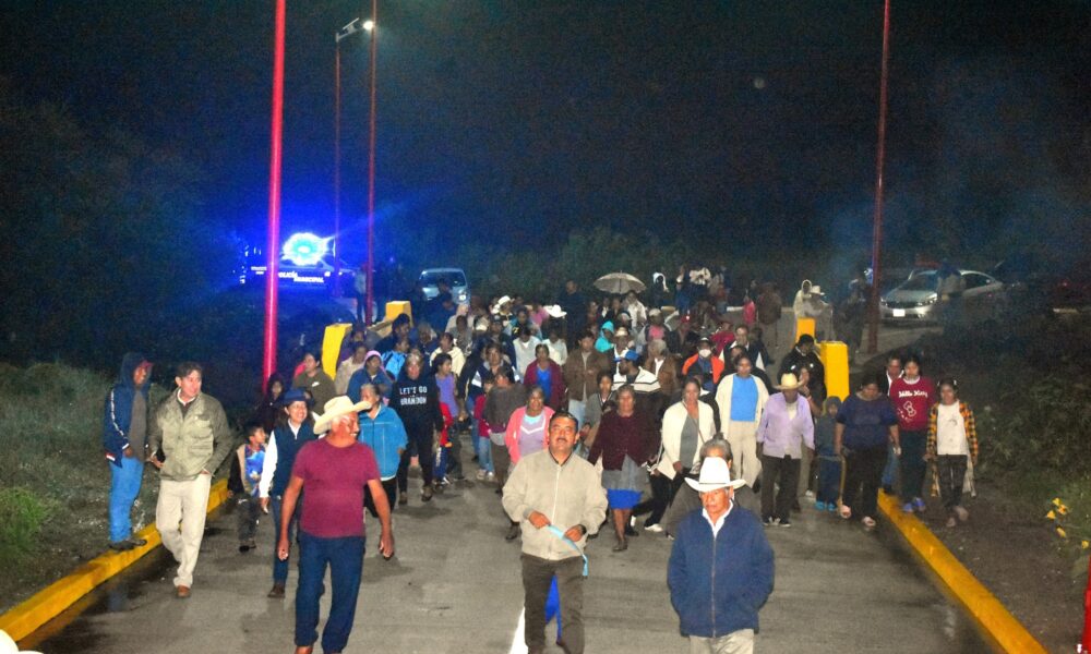 Habitantes de Cacaloxuchitl recorren las nuevas calles de concreto hidráulico durante la inauguración nocturna organizada por el Ayuntamiento de Huaquechula.