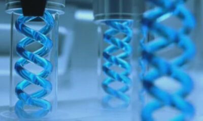 Imagen conceptual de ADN en tubos de ensayo, representando investigación biomédica y análisis genético.