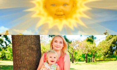 Montaje con el antiguo sol de un programa infantil con cara de bebé en el cielo y, debajo, una mujer joven sentada en el pasto abrazando a su hija pequeña en un parque.