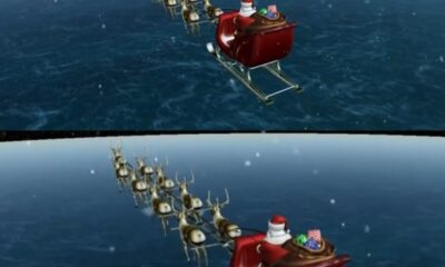 Trineo de Santa Claus sobrevolando el planeta mientras reparte regalos.