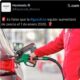 Persona cargando gasolina en vehículo en una estación de servicio