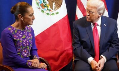 Reunión entre Claudia Sheinbaum y Donald Trump sentados frente a las banderas de México y Estados Unidos.