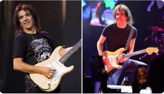 Músico tocando guitarra en escenario durante presentación en vivo