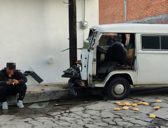 Camioneta tipo combi blanca impactada contra un poste de telefonía en la colonia Santa Rosa Chapulapa, en Atlixco, tras un accidente vial registrado la mañana del 8 de julio de 2026.